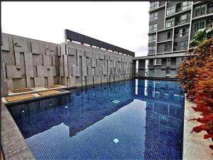 a large swimming pool in front of a building at Spaceous Appartment on Sukhumvit in Bangkok