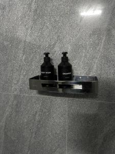 two bottles ofodorizers sitting on a shelf on a wall at Seven Crest Hotel & Restaurant in Anuradhapura