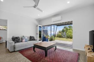 a living room with a couch and a table at Moreton View @ Tangalooma in Tangalooma
