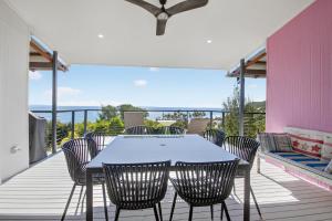 a patio with a table and chairs on a deck at Moreton View @ Tangalooma in Tangalooma