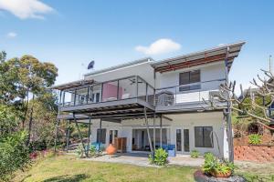 a large white house with a balcony at Moreton View @ Tangalooma in Tangalooma