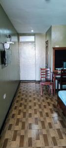 a room with a room with a table and a chair at Cherrys @ Home Too Inland Resort in Panglao