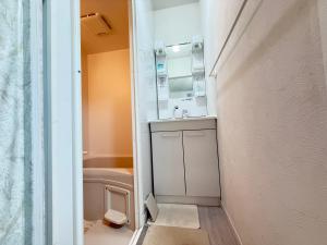 a small bathroom with a sink and a mirror at Osaka Guesthouse SAYURI HONKAN in Osaka +14 photos