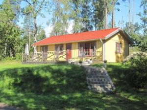 a small yellow house with a red roof at 4 person holiday home in HÅCKSVIK-By Traum in Håcksvik