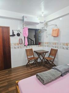 a room with a table and two chairs and a table at Homestay Khoa Chaudoc in Chau Doc +28 photos