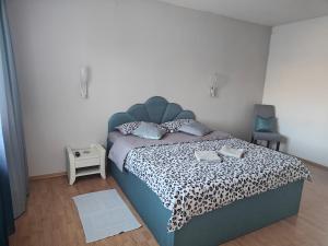 a bedroom with a bed with a leopard print bedspread at Vila Ekooos in Braşov