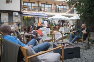 a group of people sitting in lawn chairs at ODAYA Social Hotel Bansko in Bansko
