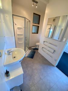 a bathroom with a sink and a shower and a toilet at The Summer House in Mangonui +22 photos