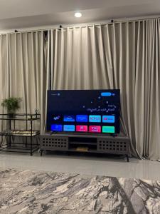 a flat screen tv sitting in front of a curtain at بيت وقف الخير اسبوعي وشهري Charity endowment house, weekly and monthly in Medina