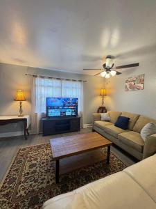 a living room with a couch and a flat screen tv at 3 bedroom Town home in Charlotte +19 photos