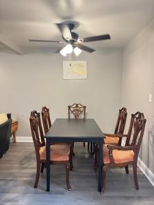 a dining room with a table and a ceiling fan at 3 bedroom Town home in Charlotte +12 photos