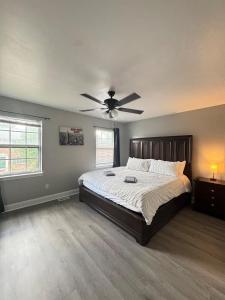 a bedroom with a bed with a ceiling fan at 3 bedroom Town home in Charlotte