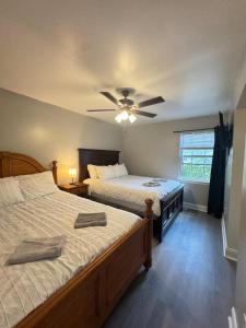 a bedroom with two beds and a ceiling fan at 3 bedroom Town home in Charlotte