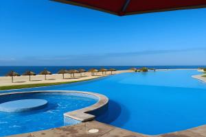 a swimming pool with a view of the ocean at Grand Venetian Comfort in Puerto Vallarta