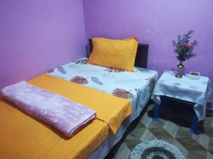 two twin beds in a room with a table at Dinu Homes Stay in Haputale +8 photos