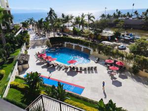 an overhead view of a pool with tables and umbrellas at Grand Venetian Comfort in Puerto Vallarta +144 photos