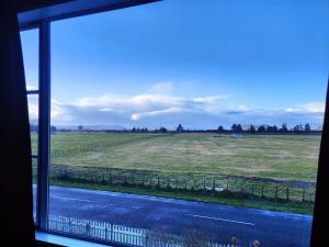 a view of a field from a window at Riverside Loft in Turangi