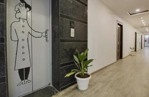 a hallway with a drawing of a woman on the wall at Townhouse 359 Begumpet Near Hyderabad Central in Hyderabad