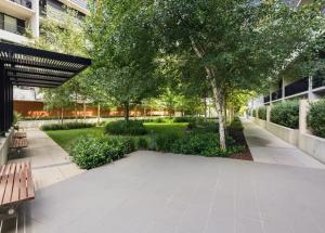 a park with benches and trees in a building at Cozy 2B apartment in Belconnen GYM POOL in Belconnen
