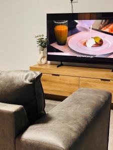 a living room with a chair and a tv at InWeFT Coastal Homes Apartment B in Swakopmund