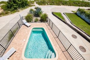 a swimming pool on a brick walkway with a swimming pool at A Pirate's Paradise in St. Augustine