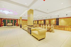a banquet hall with chairs and tables and a stage at Hotel O Kinsfolk Inn in Ghaziabad +55 photos