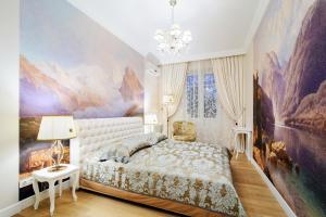 a bedroom with a bed and a painting on the wall at Vokzal Kirova 1 (2) in Minsk