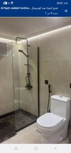 a bathroom with a toilet and a shower stall at بيتوتات التيسير in Jeddah
