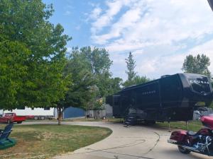 a black rv parked in a parking lot at Luxury Glamping in the Mile High - Private pool, Hot Tub, and Outdoor Fire Pit!! in Westminster