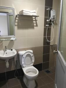 a bathroom with a toilet and a sink at Soho Hotel Semenyih in Semenyih +45 photos