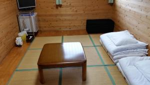 a room with a coffee table and a couch at Minnsyuku Yakushimaya in Yakushima