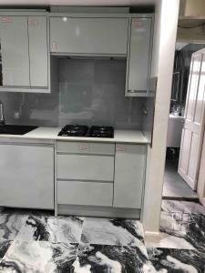 a kitchen with white cabinets and a stove at 96TR Comfy room with double bed Edmonton Green in Edmonton