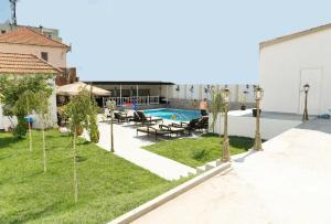 a backyard with a swimming pool and trees in it at Hotel MaRailiS Mangalia in Mangalia