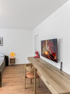 a living room with a wooden table with a fireplace at Chic City Apartment, 1BR for 2, Elegant Comfort in Wuppertal