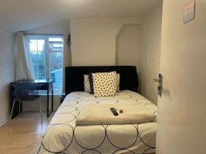 a bedroom with a bed and a desk in it at 96TR Double bed bedroom - Edmonton green in Edmonton