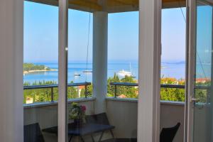 a room with windows with a view of the ocean at A&M Cavtat, sunset 3 bedrooms apartment with parking in Cavtat