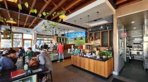 a restaurant with people sitting at a counter at Canberra CBD modern new 2B apartment free Parking in Canberra