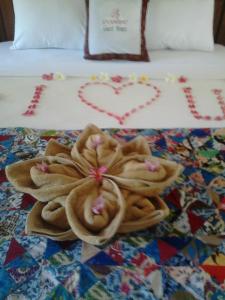 a pile of towels sitting on top of a bed at Pande Guest House in Pemuteran +66 photos