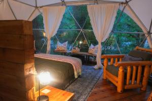 a bedroom with a tent with a bed and a table at North Cascades Glamping with Hot-tub and Outdoor Kitchen in Rockport