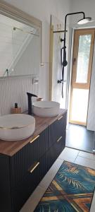 a bathroom with two sinks on top of a counter at Vila Nature and Luxury in Beliş