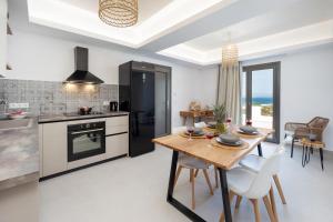 a kitchen and dining room with a table and chairs at BLUE SEA Naxos in Stelida