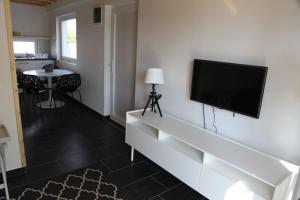 a living room with a flat screen tv on a wall at Sun City Vízisport Paradicsom in Hódmezővásárhely