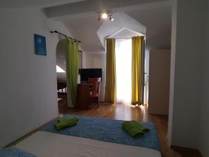 a bedroom with a bed with two green pillows on it at Apartments Andrijašević in Makarska