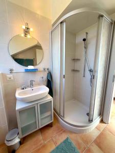 a bathroom with a shower and a sink at Nid douillet vaudois avec mezzanine in Bussigny