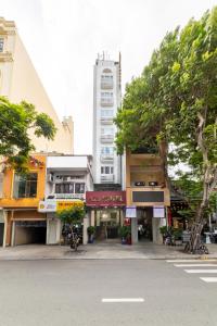 a city street with a tall building in the background at A25 Hotel - 22 Nguyễn Cư Trinh in Ho Chi Minh City