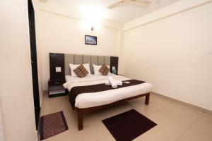 a bedroom with a large bed in a room at Hotel Baga inn in Baga