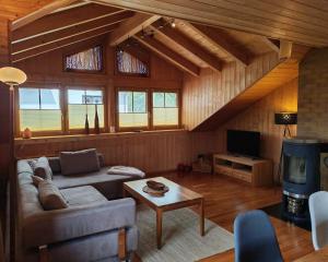 a living room with a couch and a tv at Ferienwohnung Mei Ruh' in Burggen +17 photos