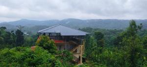 a tree house in the middle of the forest at Nisarga Coorg Home Stay in Somvārpet