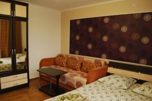 a living room with a couch and a mirror at Guest Нouse in Odesa