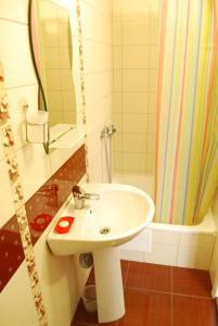 a bathroom with a white sink and a shower at Guest Нouse in Odesa +59 photos